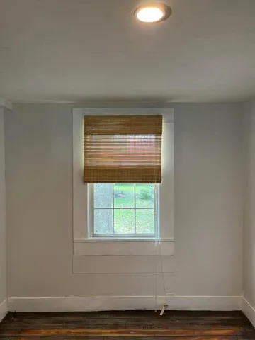 a view of wooden floor and windows in a room
