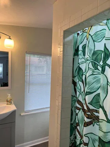 a bathroom with a shower and a sink