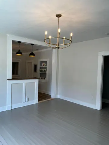 wooden floor in an empty room with a fireplace