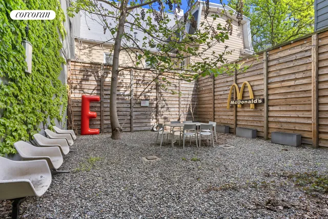 a dining room with furniture and a floor to ceiling window