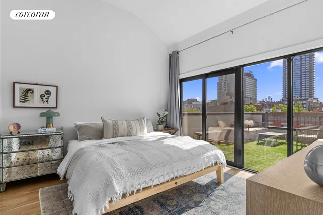 a view of a livingroom with wooden floor and stairs