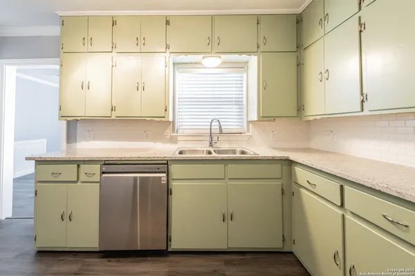 a kitchen with sink cabinets and window