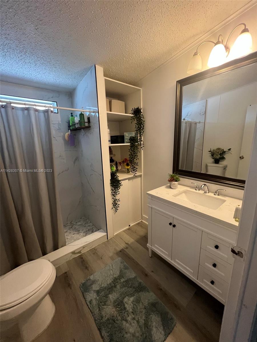 Gateway Estates Park Homestead, FL 33034 - Photo 15 of 26 a bathroom with a double vanity sink toilet and shower