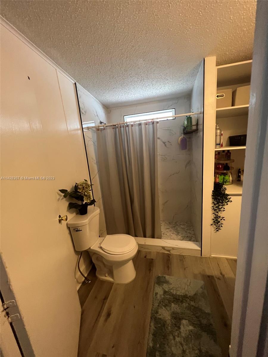 Gateway Estates Park Homestead, FL 33034 - Photo 16 of 26 a bathroom with a shower and a toilet