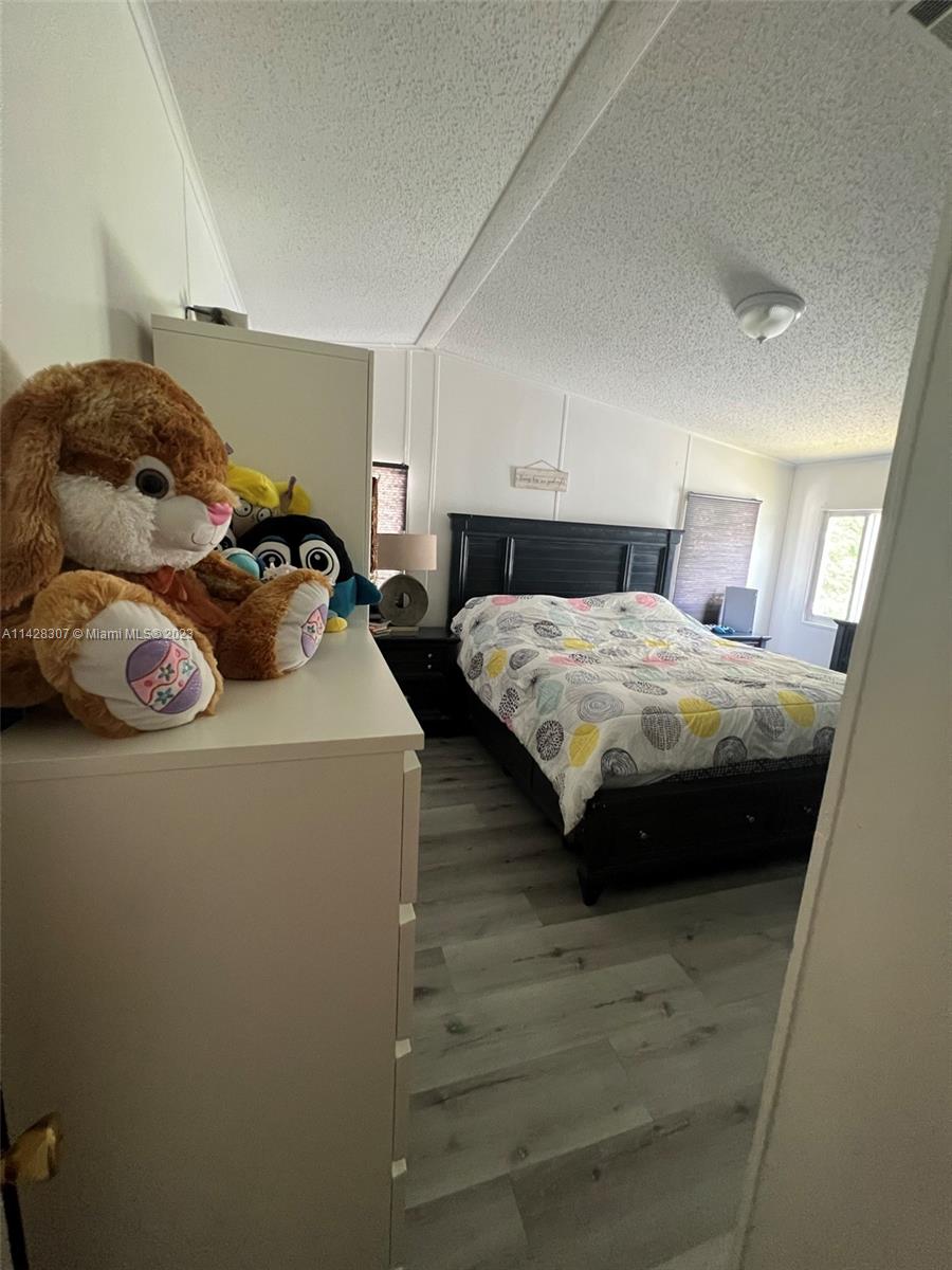 Gateway Estates Park Homestead, FL 33034 - Photo 22 of 26 a bedroom with a bed and a closet