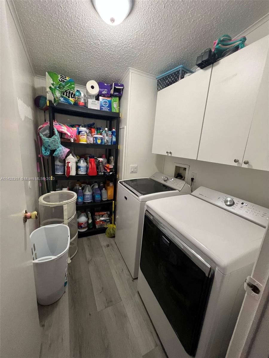 Gateway Estates Park Homestead, FL 33034 - Photo 10 of 26 a utility room with dryer washer and shoe rack
