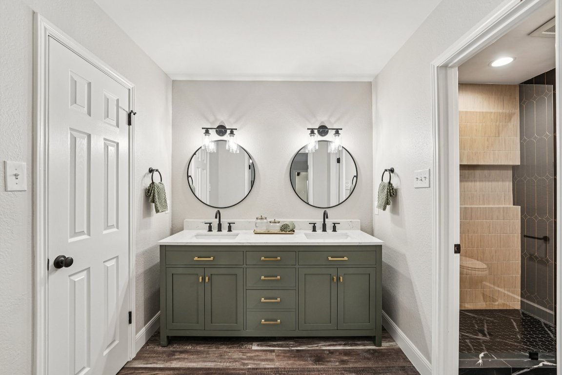 5307 Beckett Circle Austin, TX 78749 - Photo 18 of 29 Bathroom with double vanity, dark wood-type flooring, a shower stall, and recessed lighting