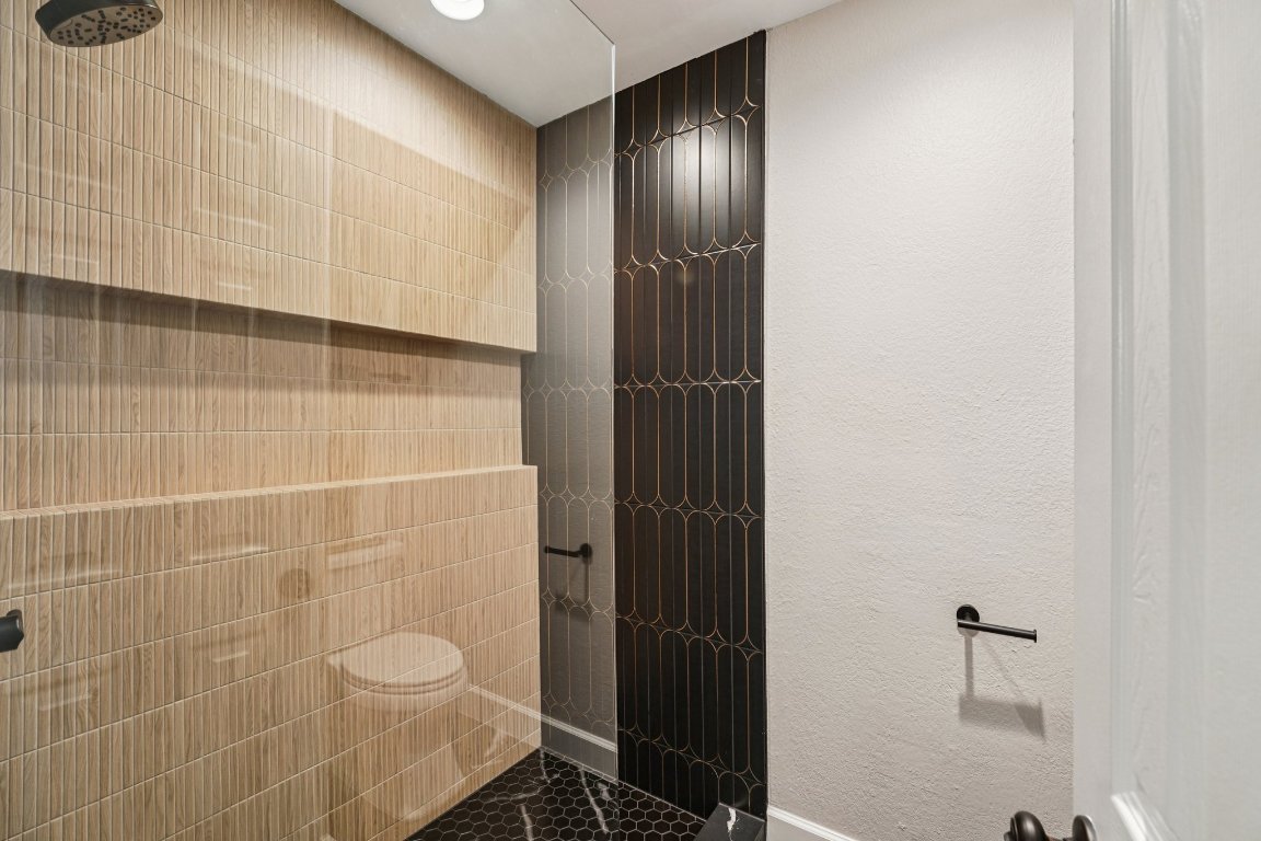 5307 Beckett Circle Austin, TX 78749 - Photo 20 of 29 Bathroom featuring a shower and a textured wall
