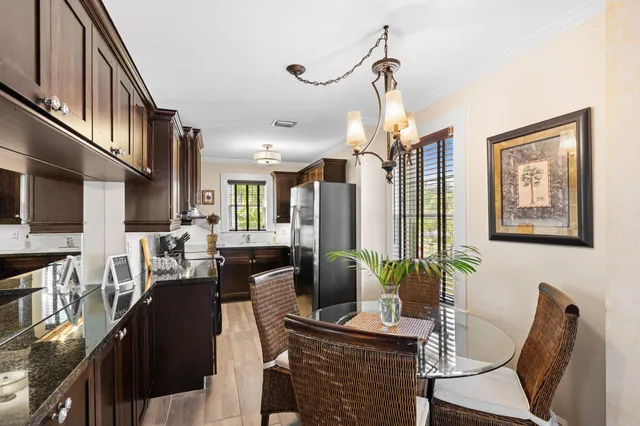 a view of a dining room with furniture a rug and wooden floor