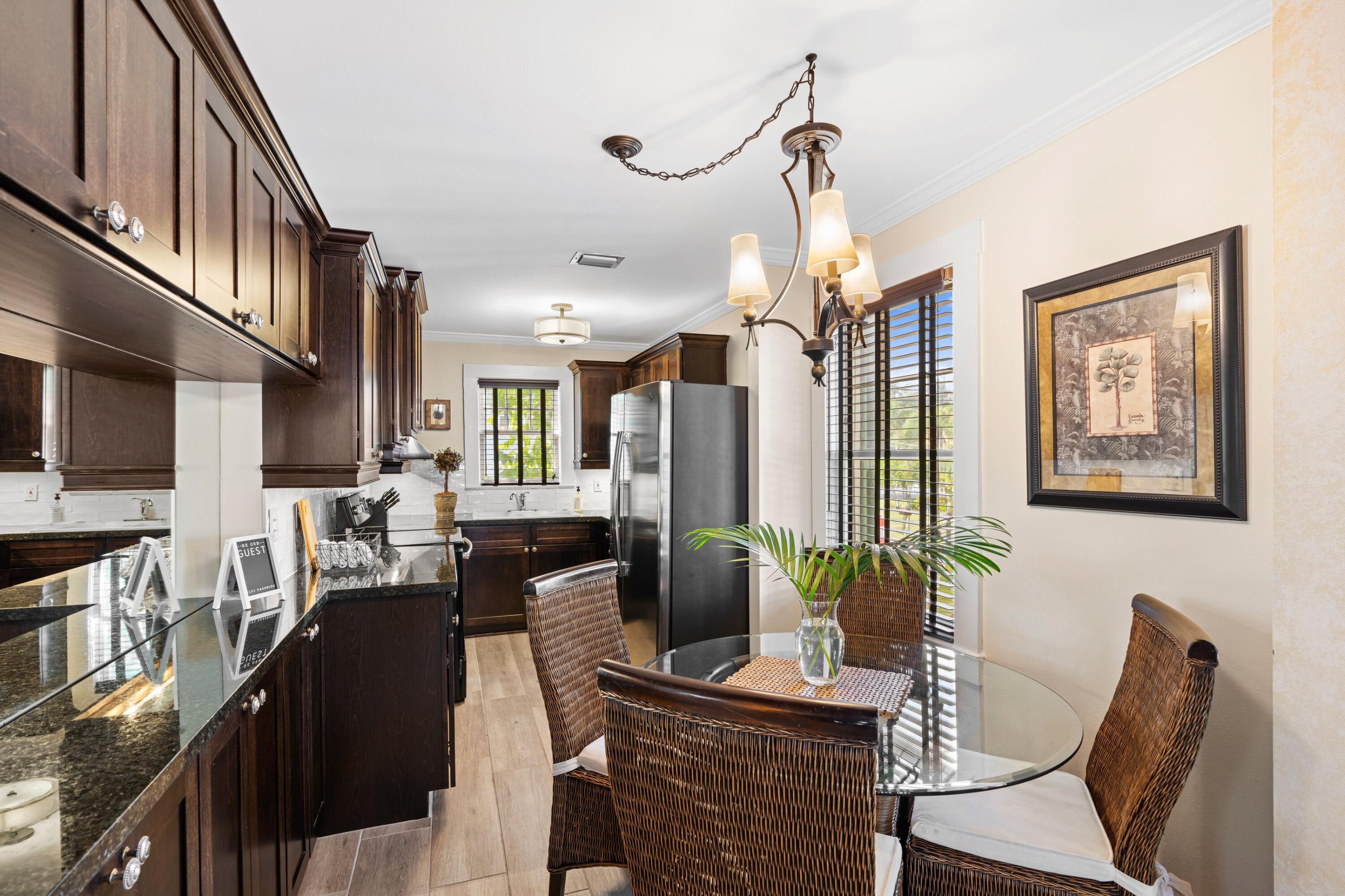 102 Southeast 7th Avenue, Unit VILLA 4 Delray Beach, FL 33483 - Photo 12 of 23 a view of a dining room with furniture a rug and wooden floor
