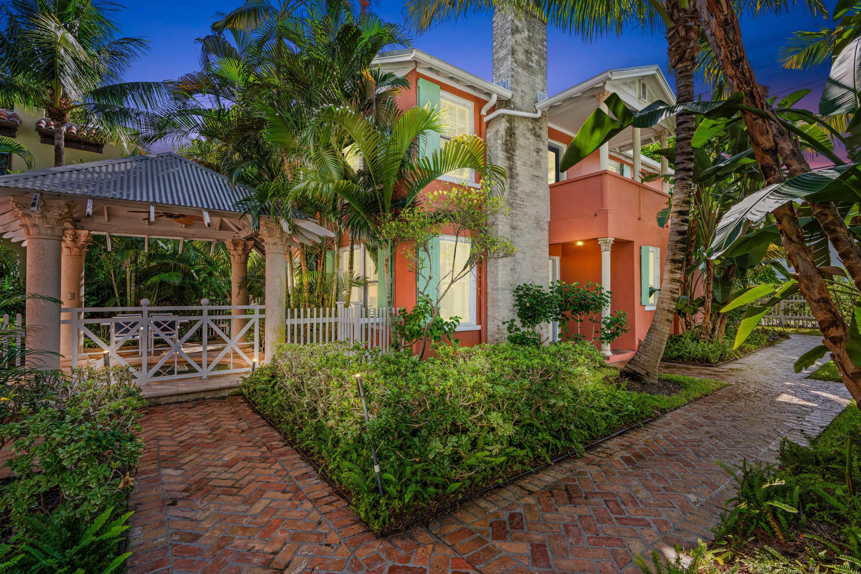 102 Southeast 7th Avenue, Unit VILLA 4 Delray Beach, FL 33483 - Photo 19 of 23 a view of a patio with table and chairs potted plants and large tree