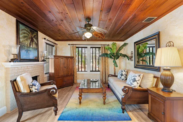a living room with furniture fireplace and a large window