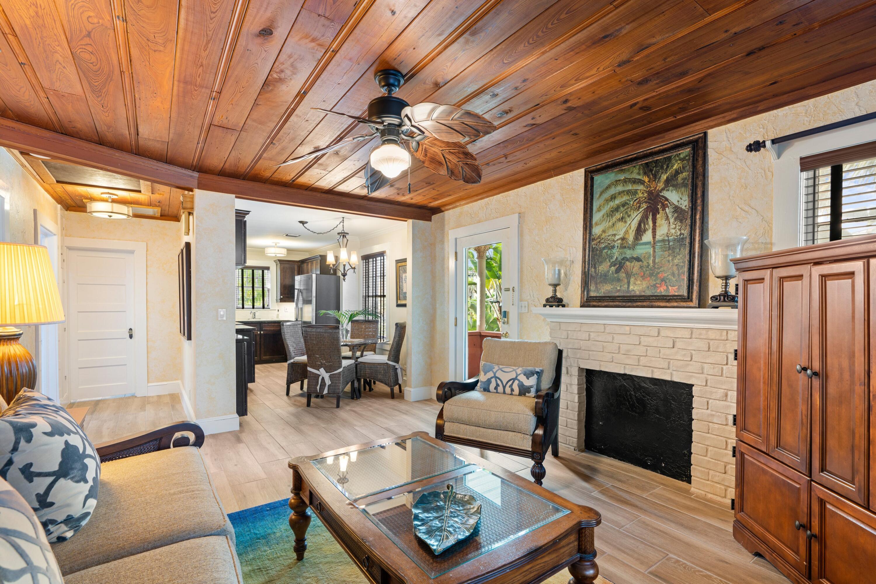 102 Southeast 7th Avenue, Unit VILLA 4 Delray Beach, FL 33483 - Photo 10 of 23 a living room with furniture a fireplace and a table