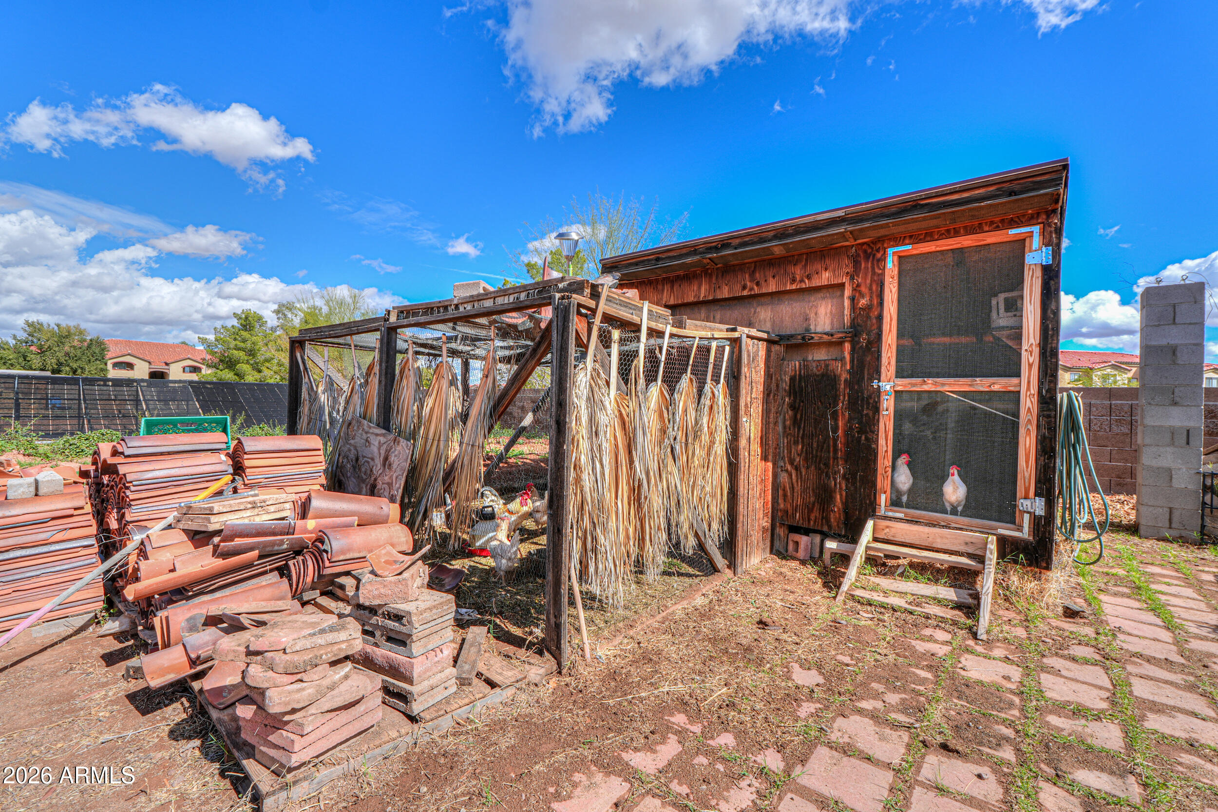 340 North Pottebaum Road Casa Grande, AZ 85122 - Photo 42 of 49 a backyard of a house with barbeque oven table and chairs