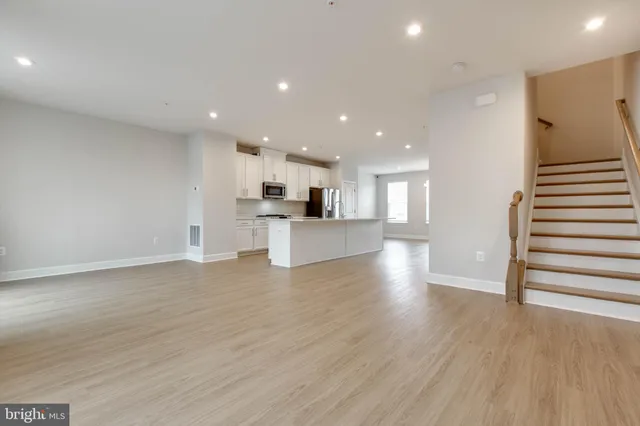 a view of kitchen with wooden floor and electronic appliances