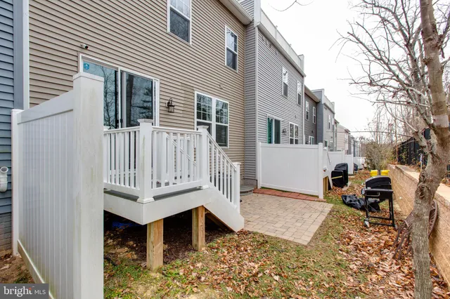 a view of a house with a wooden fence