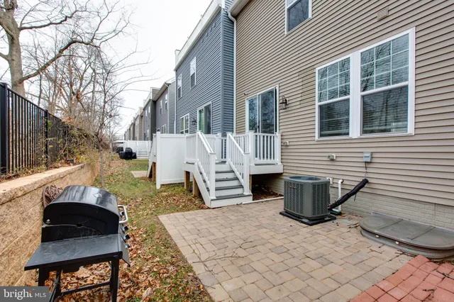 a view of a patio with table and chairs and wooden fence