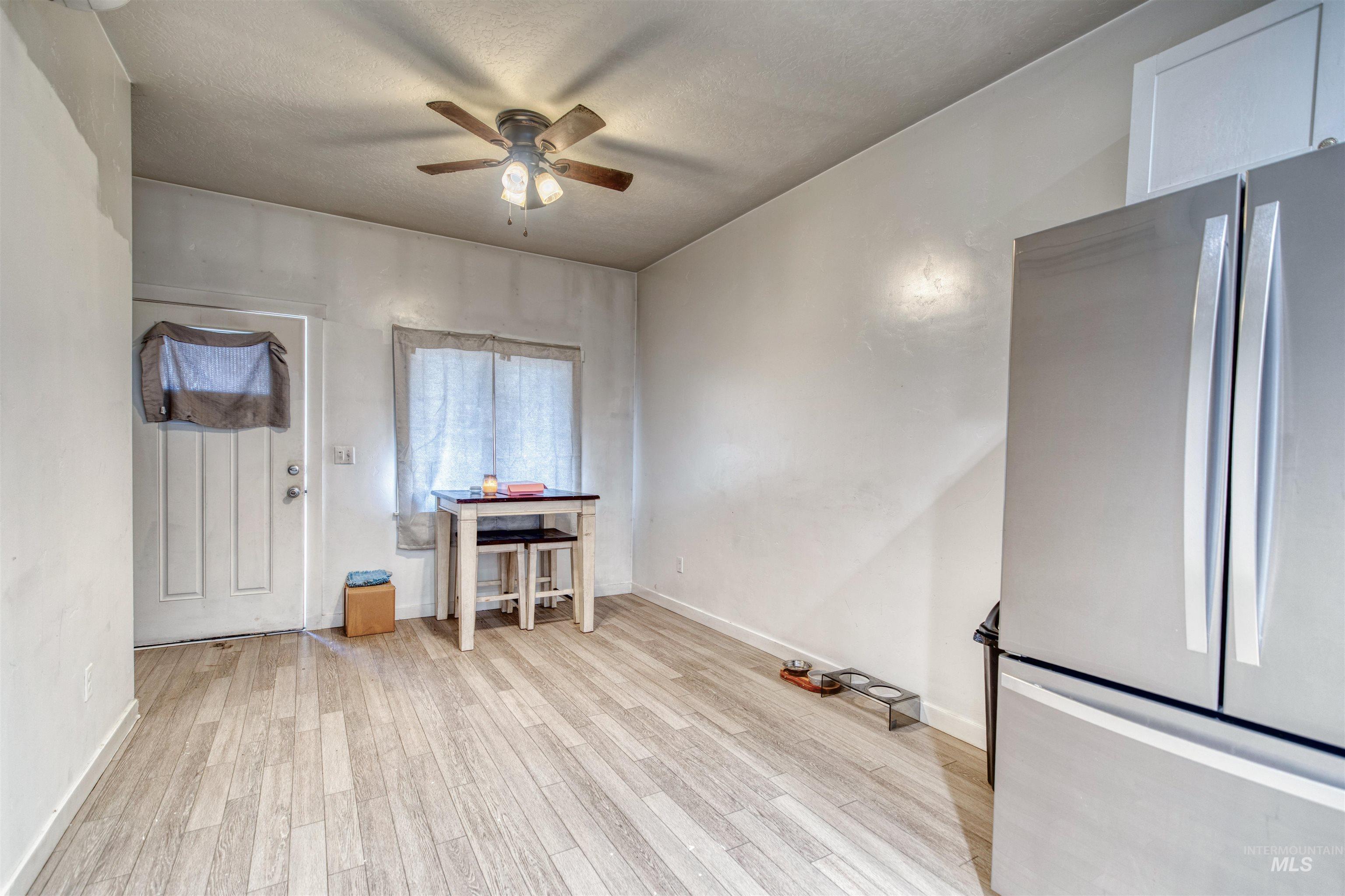 112 East Main Street Nyssa, OR 97913 - Photo 18 of 43 Dining area featuring ceiling fan, light wood finished floors, and a textured ceiling