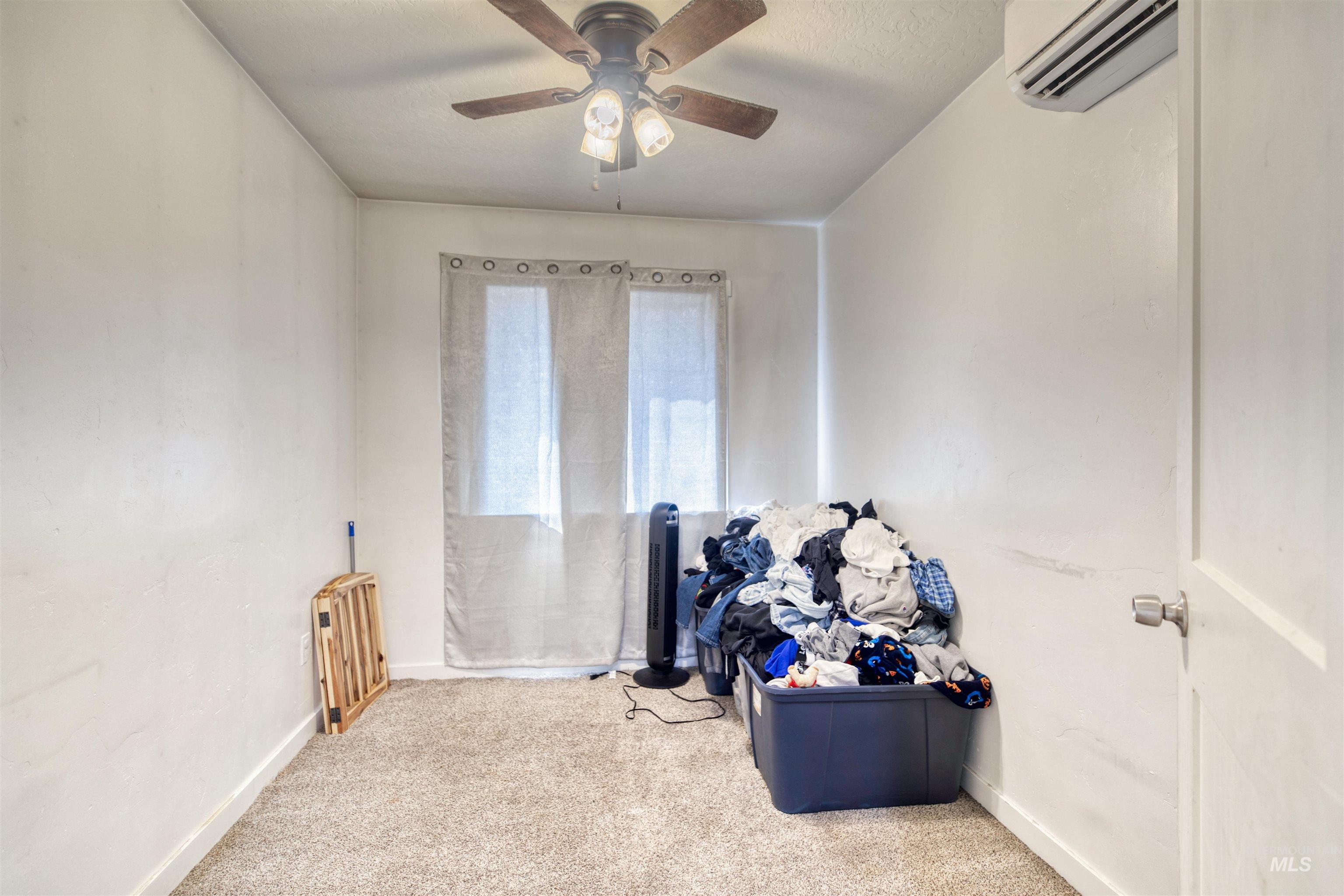 112 East Main Street Nyssa, OR 97913 - Photo 20 of 43 Misc room featuring carpet flooring, an AC wall unit, and a ceiling fan