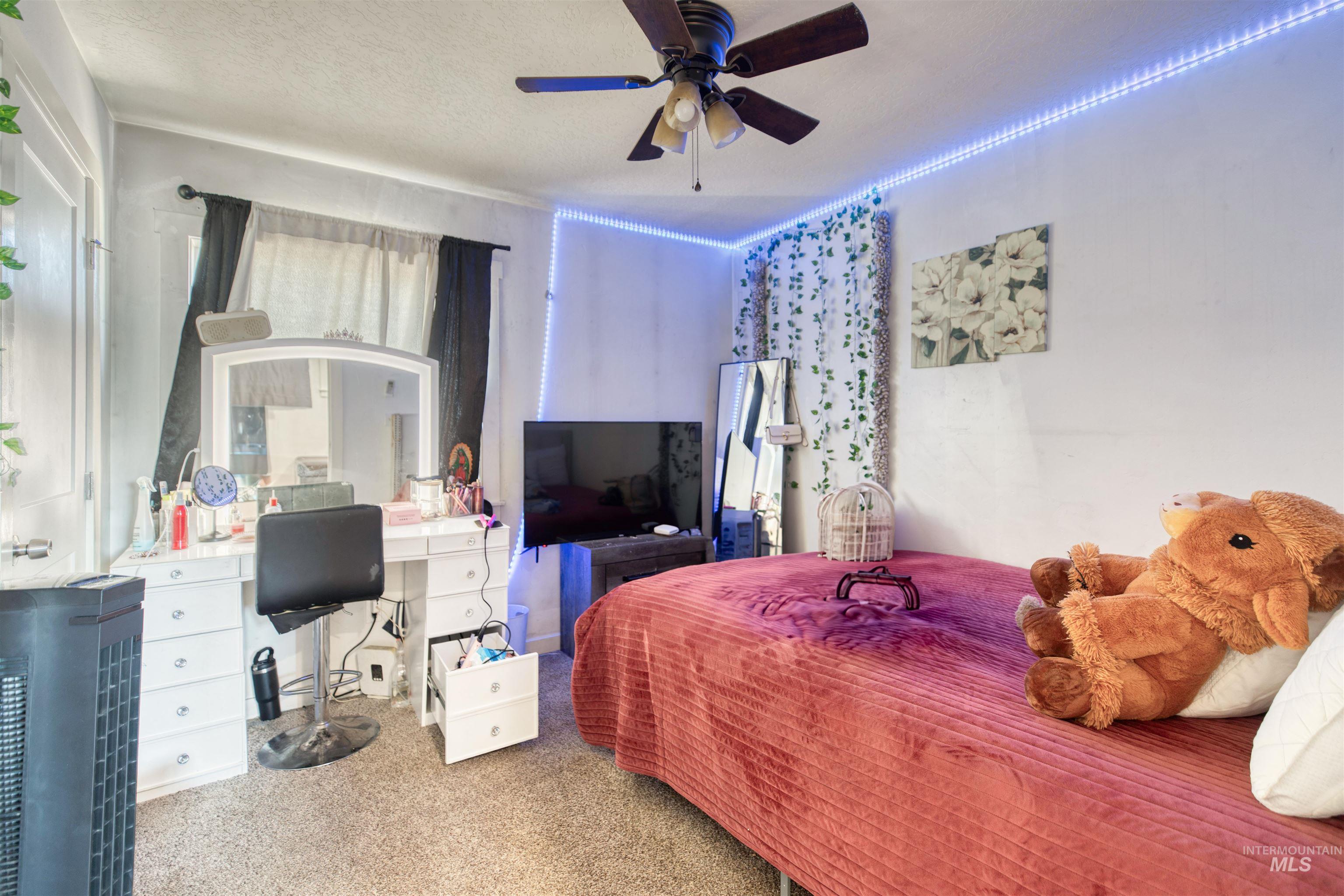 112 East Main Street Nyssa, OR 97913 - Photo 25 of 43 Carpeted bedroom featuring a desk, a textured ceiling, and a ceiling fan