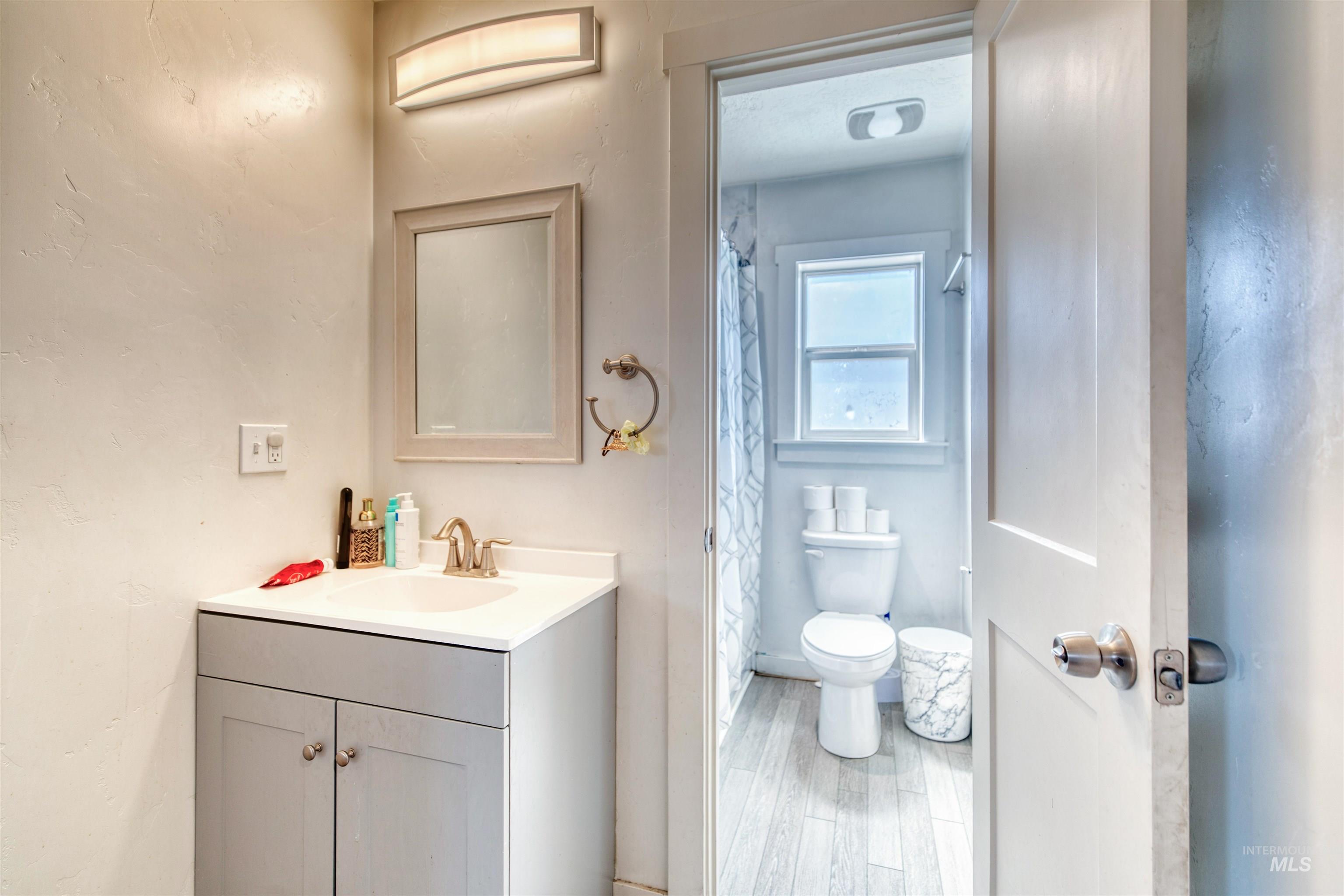 112 East Main Street Nyssa, OR 97913 - Photo 26 of 43 Bathroom with vanity, wood finished floors, and curtained shower