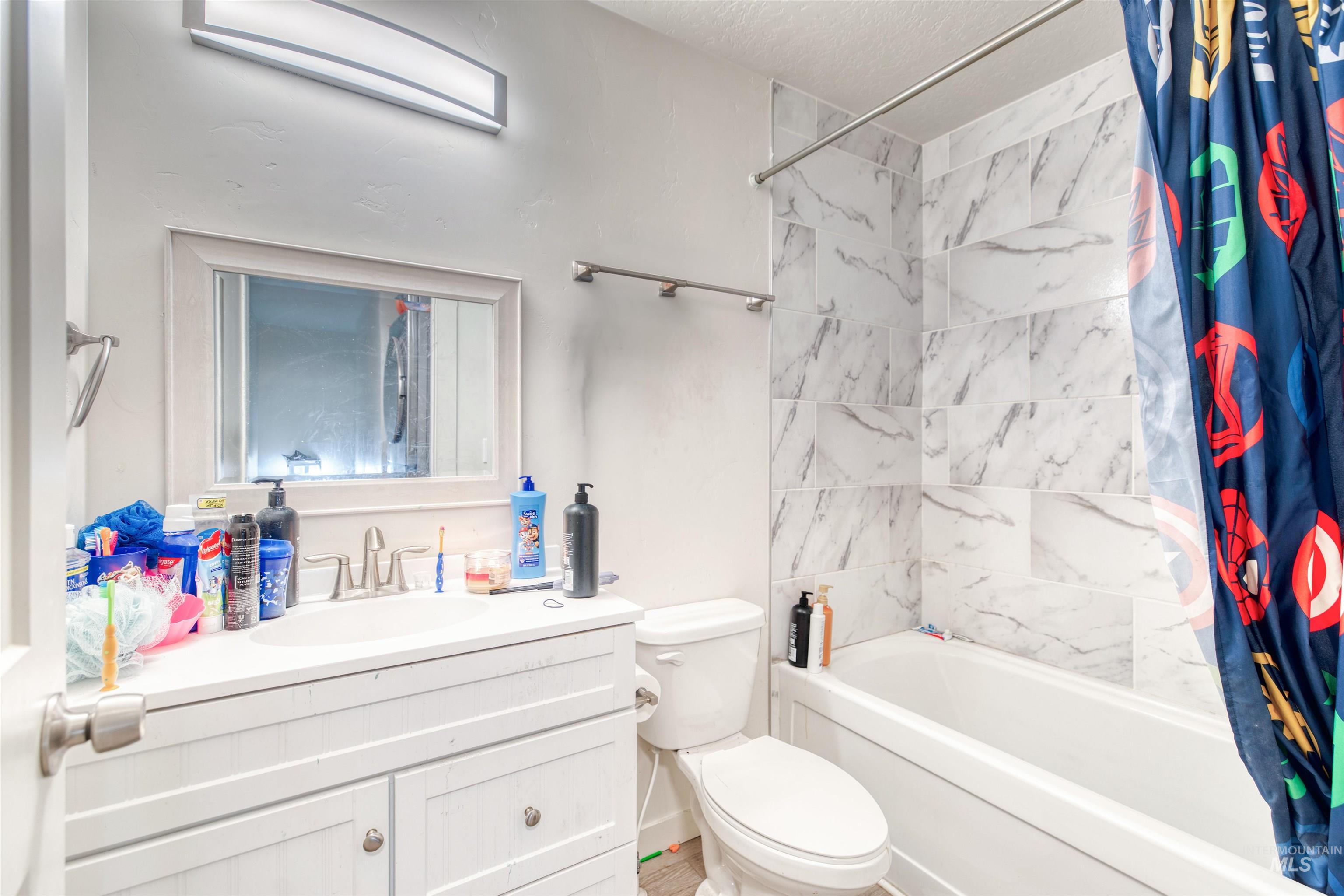 112 East Main Street Nyssa, OR 97913 - Photo 35 of 43 Bathroom with vanity, shower / bath combo, and a textured ceiling