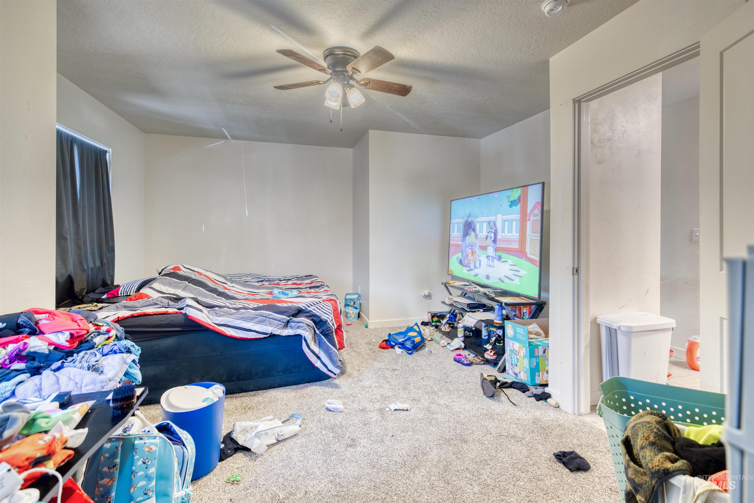112 East Main Street Nyssa, OR 97913 - Photo 41 of 43 Bedroom with carpet flooring, a textured ceiling, attic access, and a ceiling fan