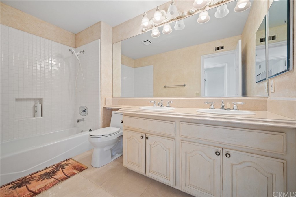 16 Charmony Laguna Niguel, CA 92677 - Photo 17 of 36 a bathroom with a toilet a sink a mirror a bathtub and shower