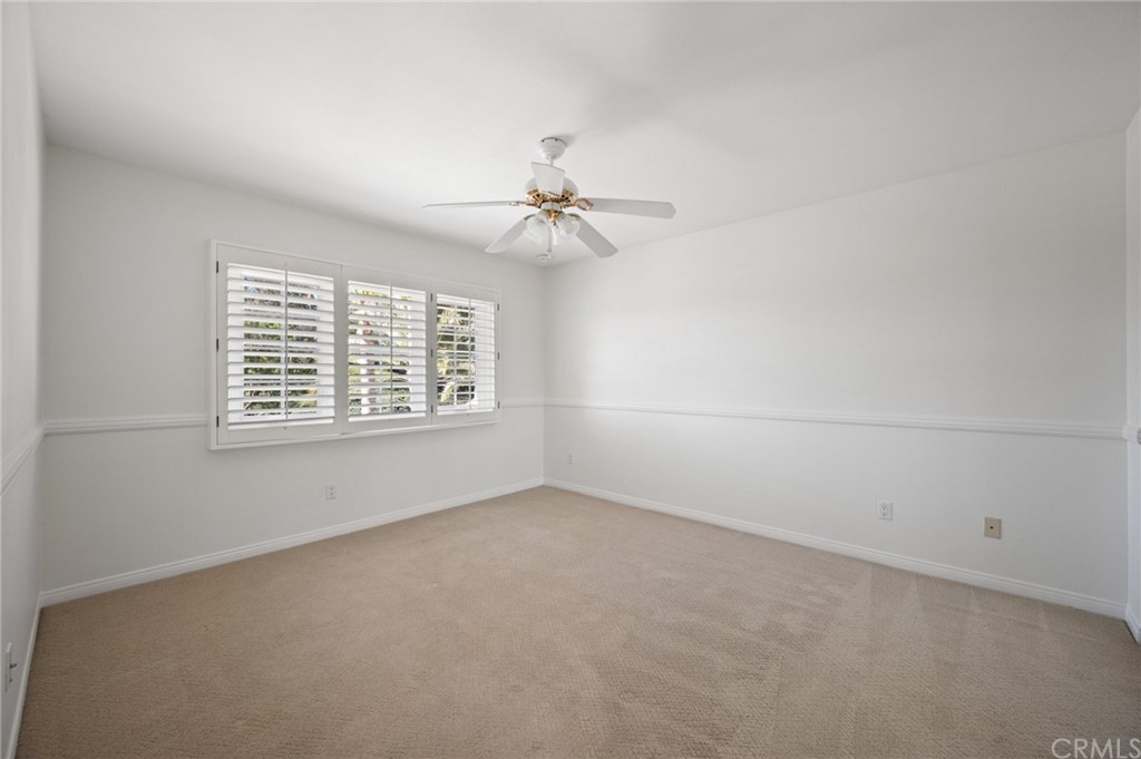 16 Charmony Laguna Niguel, CA 92677 - Photo 18 of 36 an empty room with windows and chandelier fan