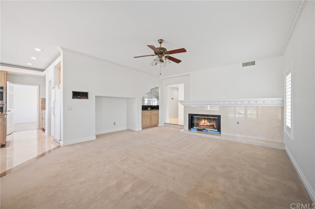 16 Charmony Laguna Niguel, CA 92677 - Photo 24 of 36 a view of a livingroom with a fireplace and a chandelier fan