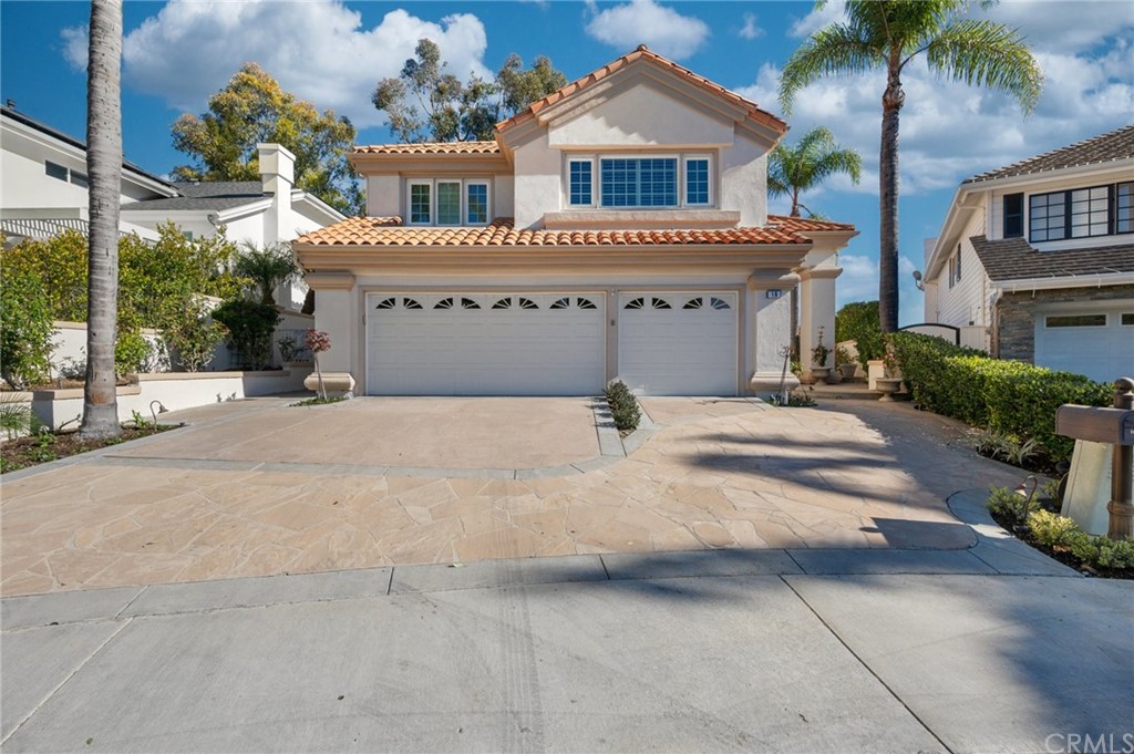 16 Charmony Laguna Niguel, CA 92677 - Photo 26 of 36 a front view of a house with a yard and garage