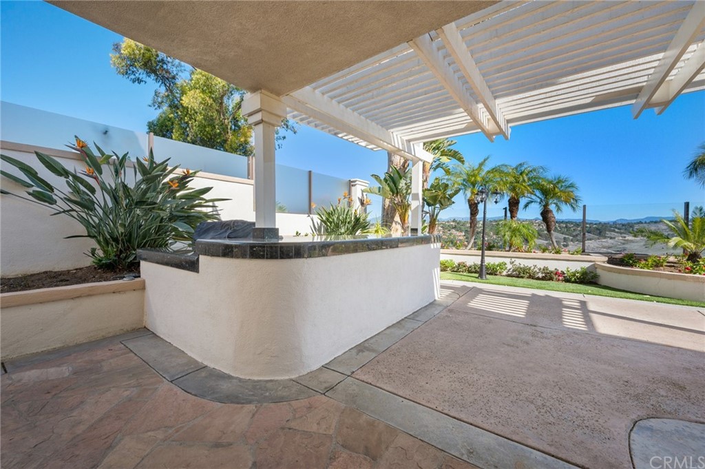 16 Charmony Laguna Niguel, CA 92677 - Photo 6 of 36 a view of a terrace with a bench and potted plants