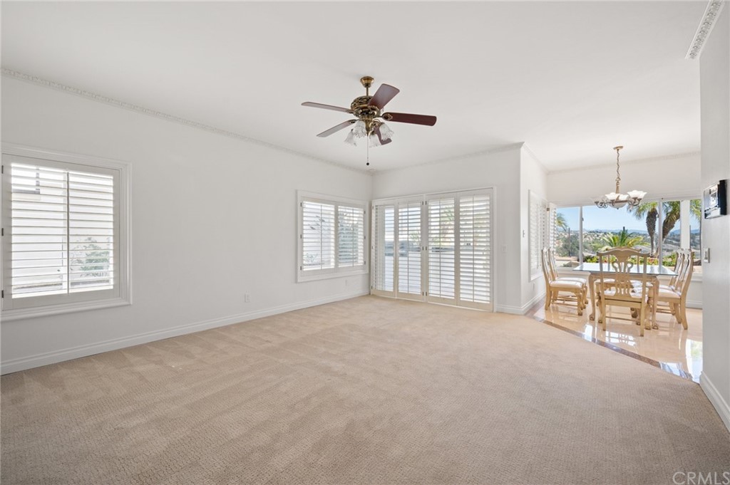 16 Charmony Laguna Niguel, CA 92677 - Photo 10 of 36 a big room with windows and chandelier fan