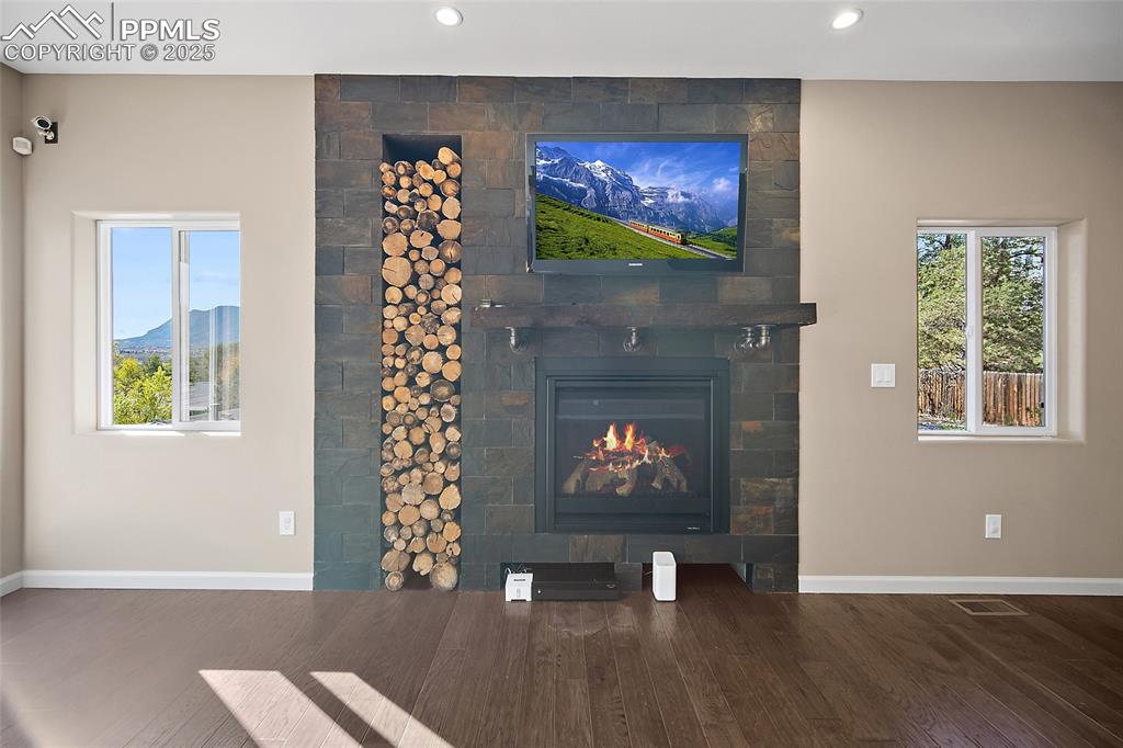 633 Tierra Verde Court Colorado Springs, CO 80904 - Photo 13 of 50 a living room with furniture a fireplace and a flat screen tv