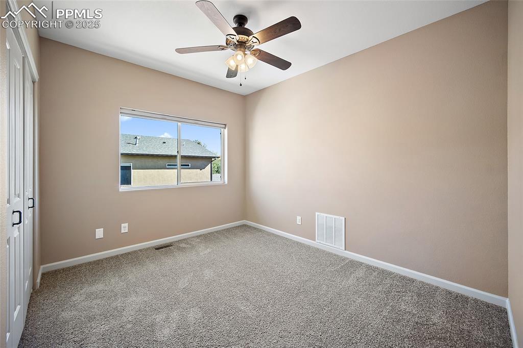633 Tierra Verde Court Colorado Springs, CO 80904 - Photo 30 of 50 an empty room with windows and fan