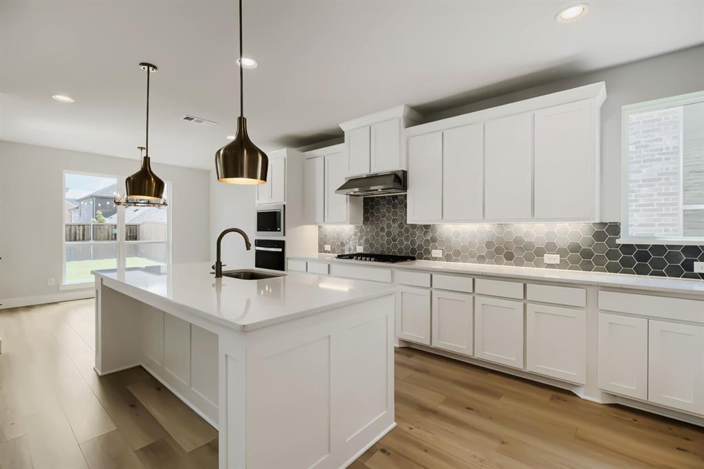 4414 Windy Point Road Oak Point, TX 75068 - Photo 10 of 27 a kitchen with white cabinets and sink