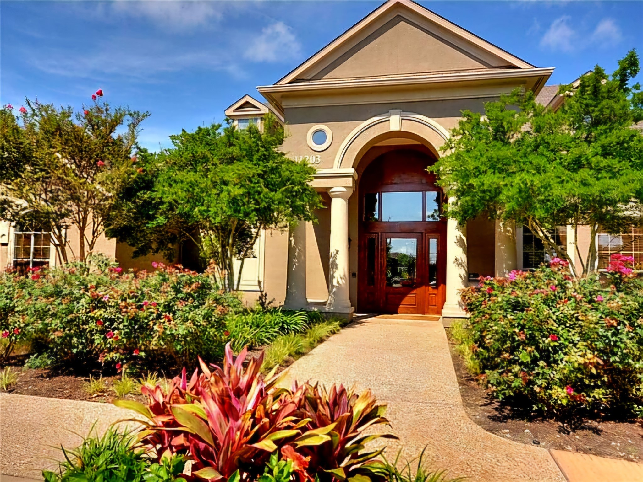 a front view of a house with a garden