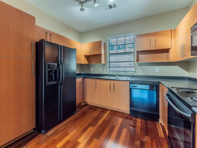 a kitchen with stainless steel appliances granite countertop a refrigerator and a stove