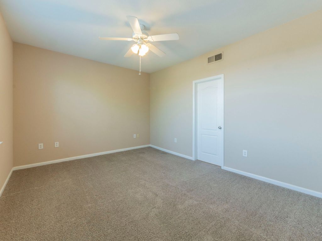 11203 Ranch Road 2222, Unit 107 Austin, TX 78730 - Photo 14 of 33 an empty room with a chandelier fan