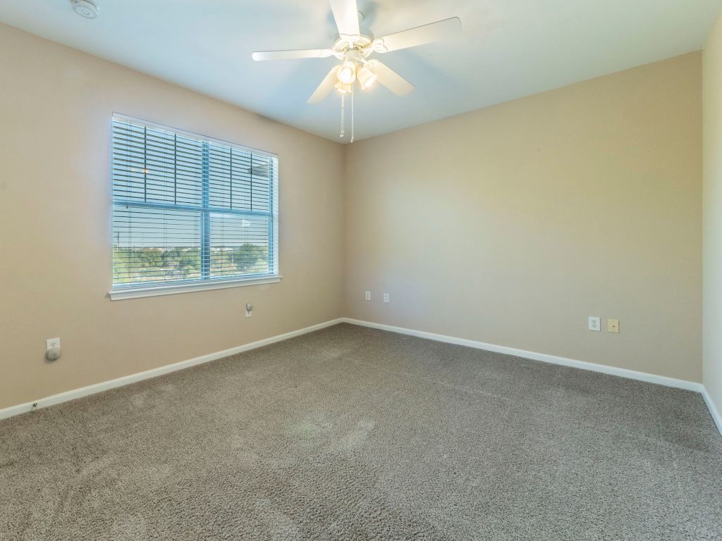 11203 Ranch Road 2222, Unit 107 Austin, TX 78730 - Photo 15 of 33 an empty room with a window and a fan
