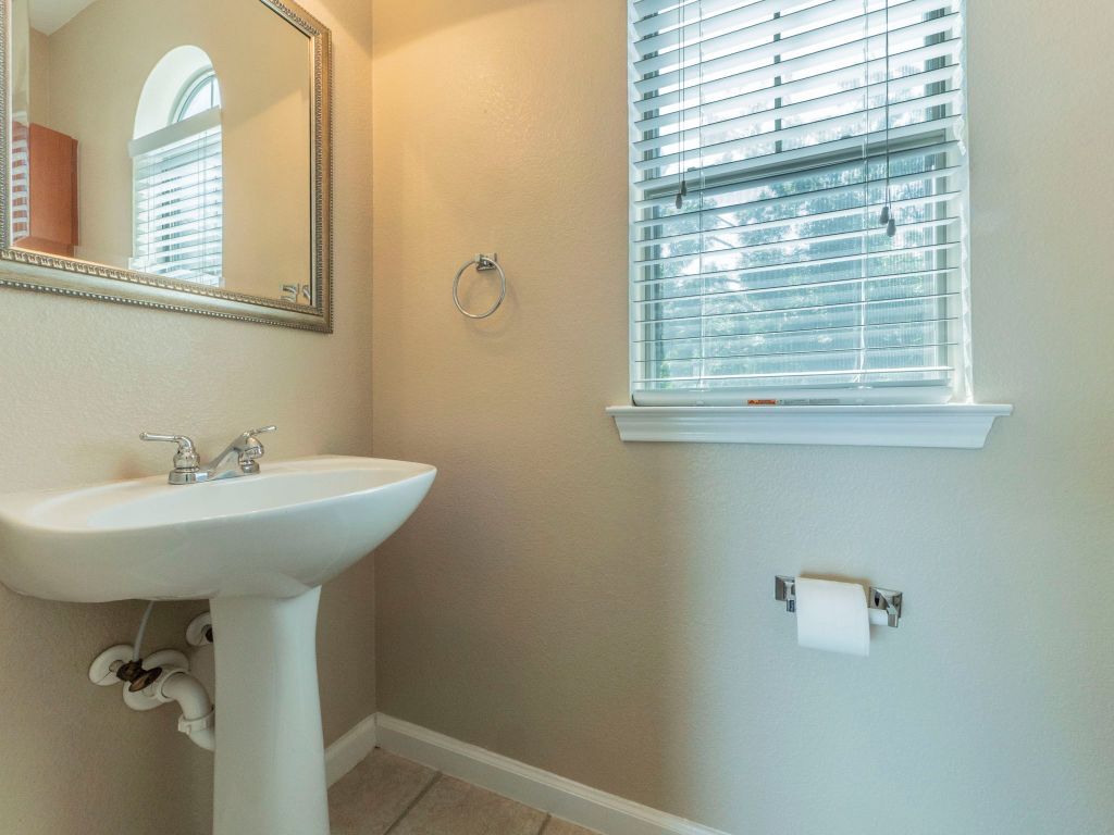 11203 Ranch Road 2222, Unit 107 Austin, TX 78730 - Photo 17 of 33 a bathroom with a sink a window and a shower