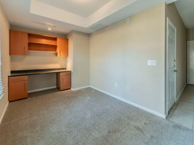 an empty room with a kitchen
