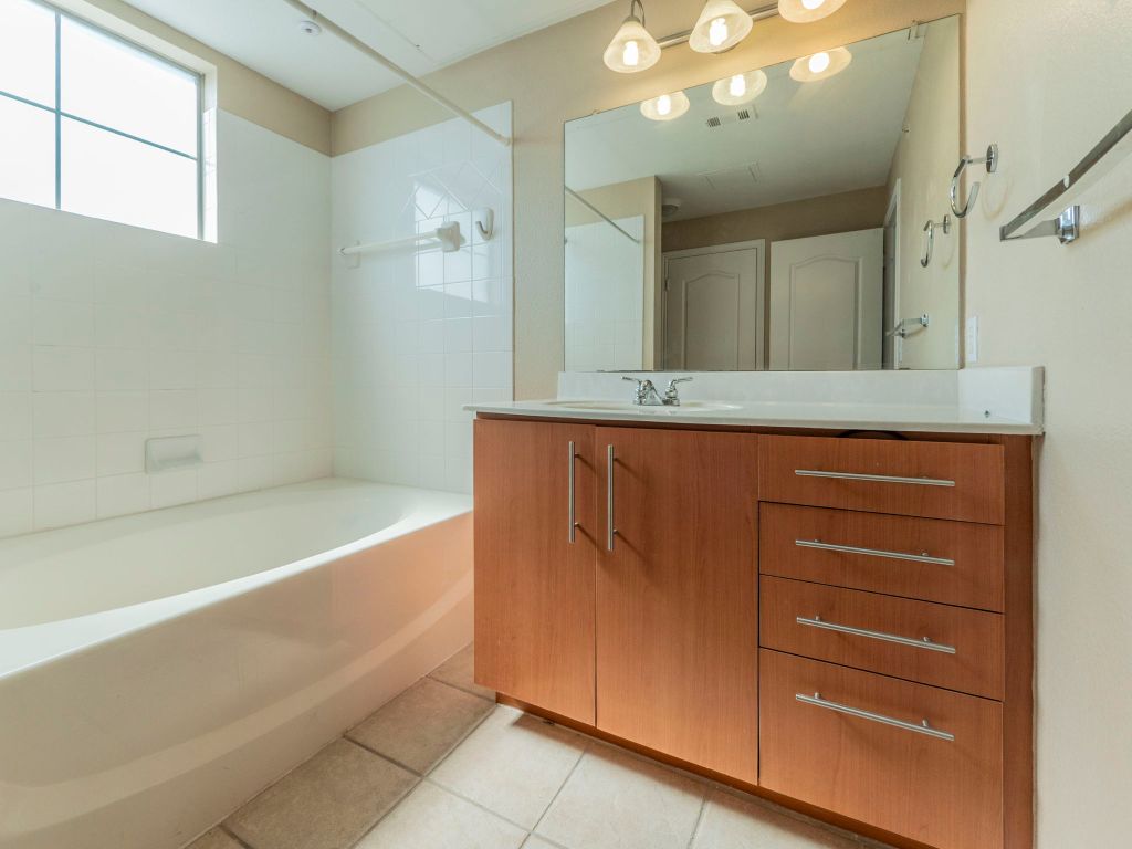11203 Ranch Road 2222, Unit 107 Austin, TX 78730 - Photo 20 of 33 a bathroom with a bathtub sink and mirror