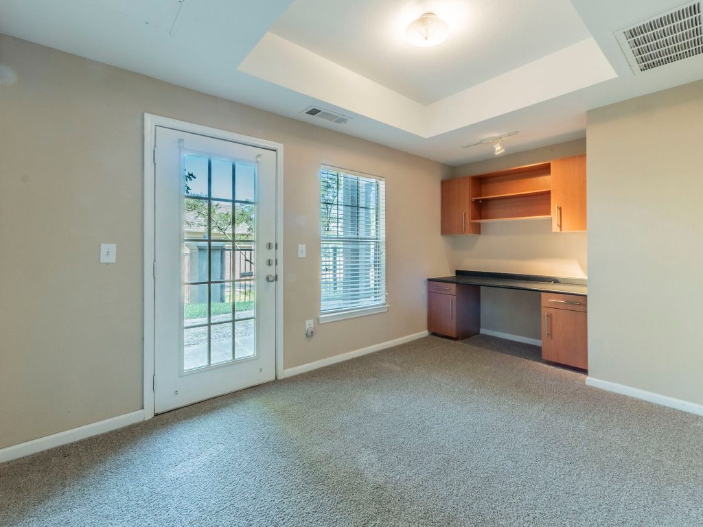 11203 Ranch Road 2222, Unit 107 Austin, TX 78730 - Photo 21 of 33 an empty room with windows & cabinet