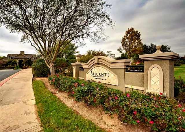a view of a street sign under a large tree