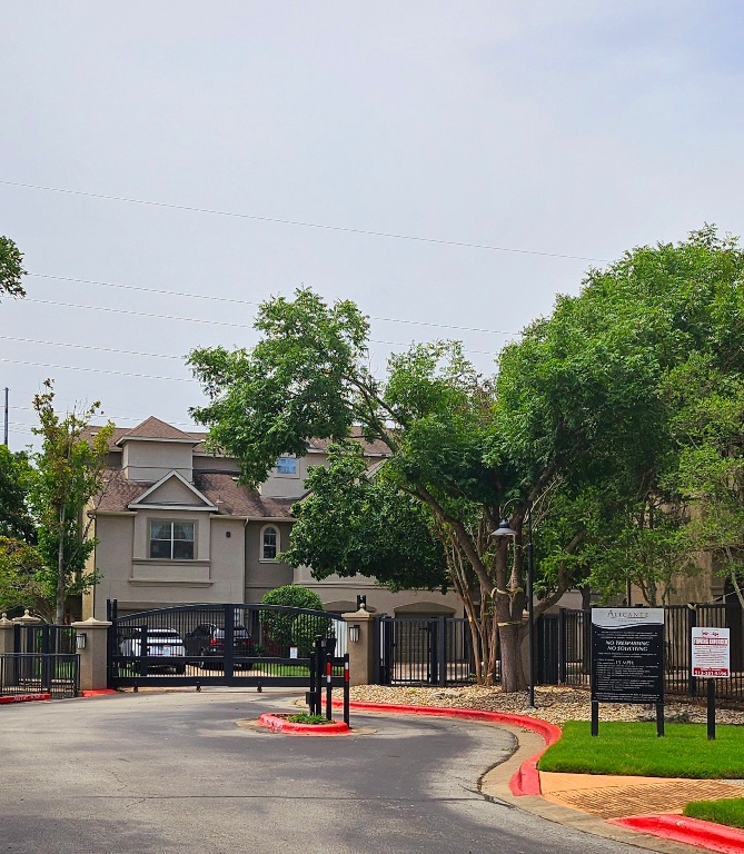 11203 Ranch Road 2222, Unit 107 Austin, TX 78730 - Photo 27 of 33 a front view of a house with a yard