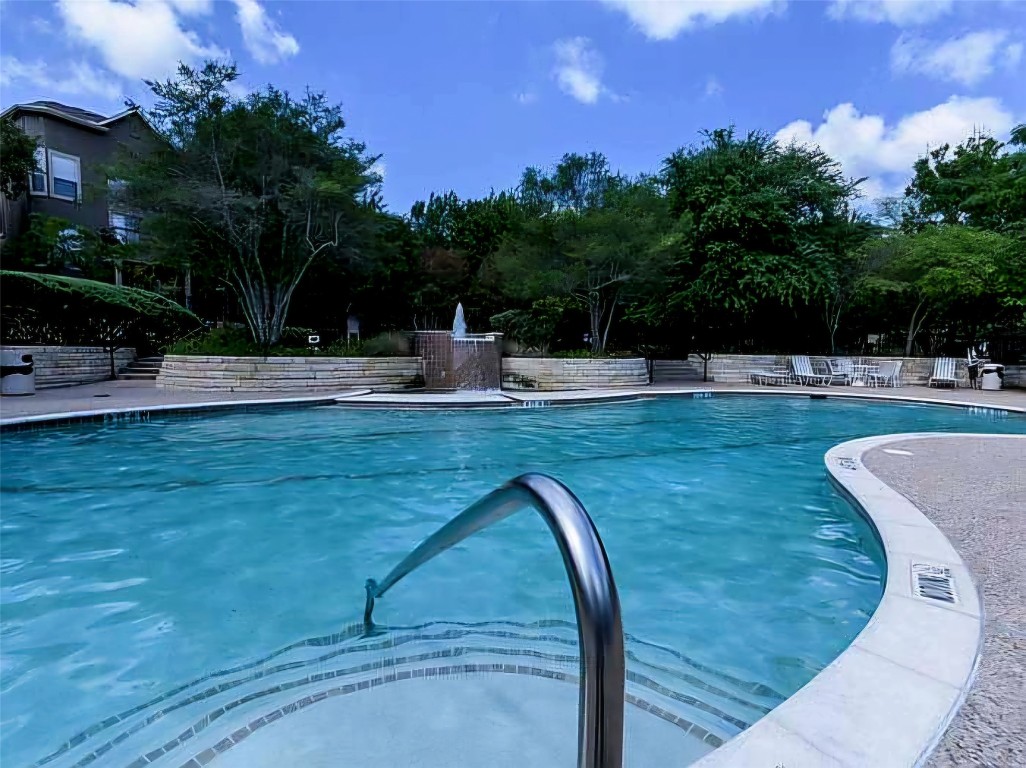 11203 Ranch Road 2222, Unit 107 Austin, TX 78730 - Photo 31 of 33 a view of a swimming pool with a yard