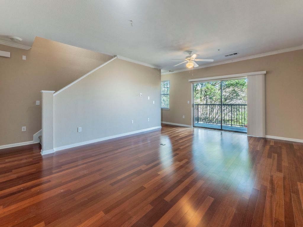 11203 Ranch Road 2222, Unit 107 Austin, TX 78730 - Photo 7 of 33 a view of an empty room with wooden floor and a window