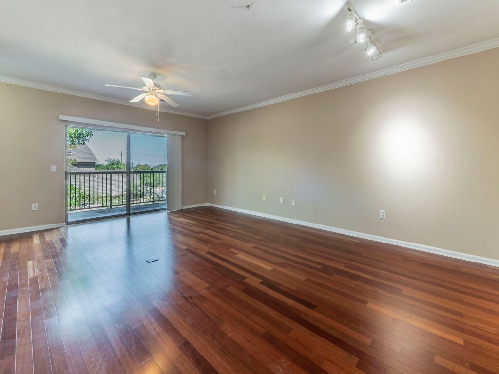11203 Ranch Road 2222, Unit 107 Austin, TX 78730 - Photo 8 of 33 a view of room with wooden floor and fan