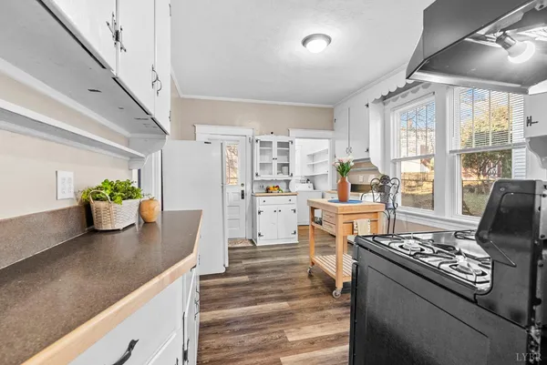 a kitchen with stove and refrigerator